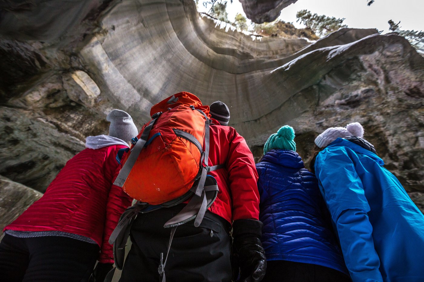 People Looking Up Through Cave